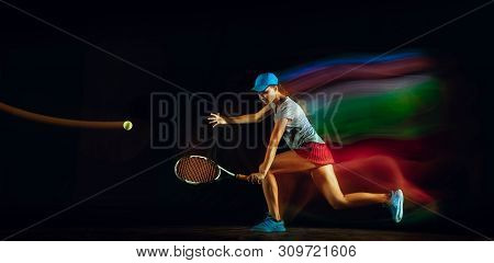 One Caucasian Woman Playing Tennis Isolated On Black Background In Mixed And Stobe Light. Fit Young 