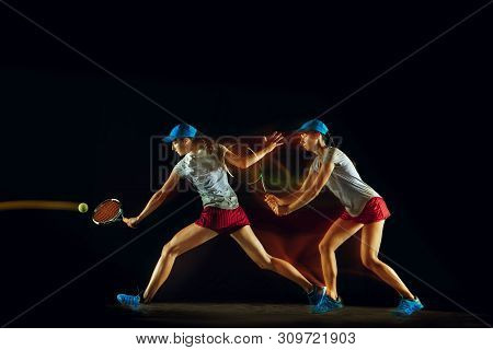 One Caucasian Woman Playing Tennis Isolated On Black Background In Mixed And Stobe Light. Fit Young 
