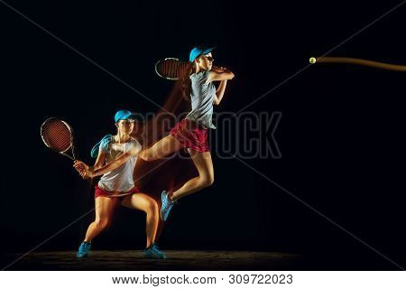One Caucasian Woman Playing Tennis Isolated On Black Background In Mixed And Stobe Light. Fit Young 