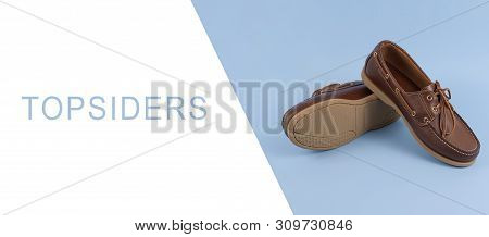 Brown Mens Topsiders Shoes On Blue Background With Reflection. Fashion Advertising Shoes. Copy Space