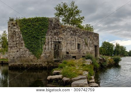 Amares, Portugal - June 20, 2019 : Ruins Of A Mill On The Green Banks Of The River Cávado In Braga, 