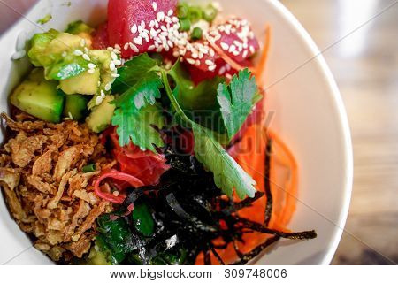 Raw Organic Ahi Tuna Poke Bowl With Rice And Veggies