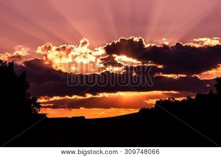 Colorful Sunset With Clouds And Black Horizon