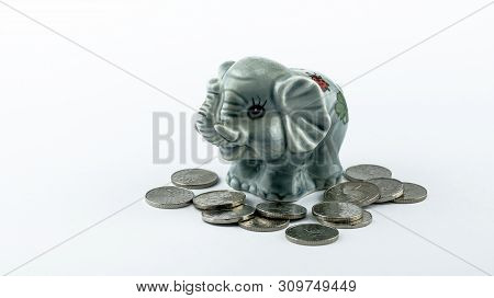 Moneybox Of An Elephant With Czech Coins Around Isolated On A White Background.