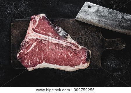 Dry Aged Beef Raw T-bone Steak On Vintage Cutting Board