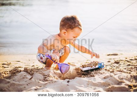 Kids Play On Beach. Sand And Water Toy. Truck Toy Car With Sand And Soil. Green Environment Construc