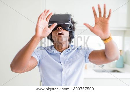 African amaerican man having fun playing with virtual reality glasses