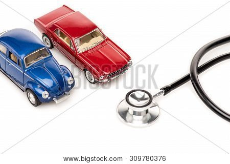 Kyiv, Ukraine - May 14, 2019: Red And Blue Toy Cars And Stethscope Isolated On White Surface