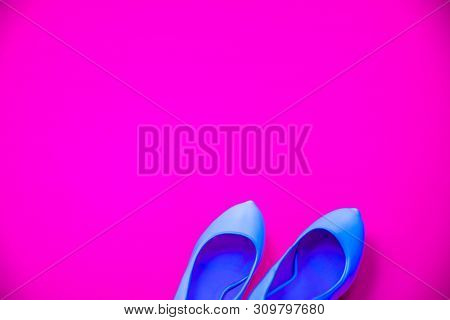 Blue High Heeled Shoes Pink Purple Background - Top View - Heels Pointing Right