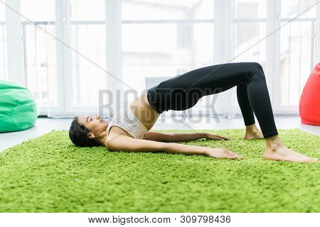 Young Sporty Woman Practicing Yoga, Doing Dvi Pada Pithasana Exercise, Glute Bridge Pose, Working Ou