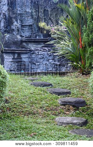 A Curvaceous Foothpath Made Of Concrete Blocks At A Park