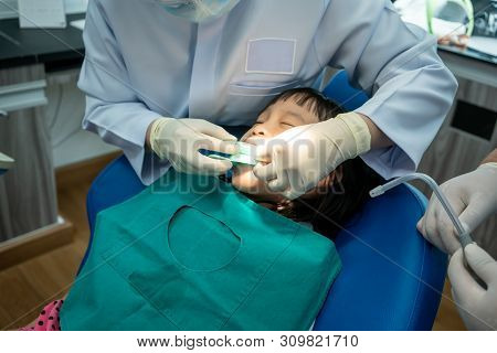 Asian Girl Met The Dentist For Routine Dental Checkup And Consultant.