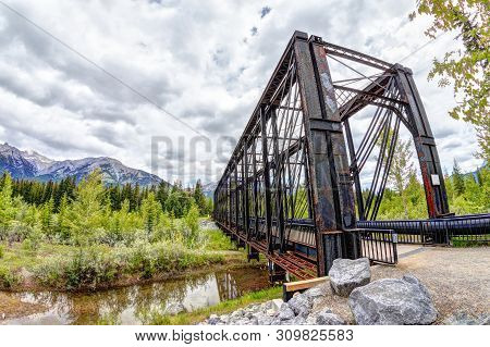 Historic Canmore Engine Bridge Over The Bow River In The Canadian Rockies. The Railway Bridge Was Bu