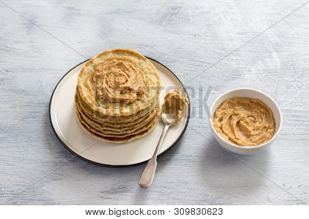 Vegan Pancakes With Flax Seeds, Peanut Butter And Vegan Milk On A White Plate On A Gray Background. 
