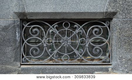 The Basement Window With A Metal Barrier
