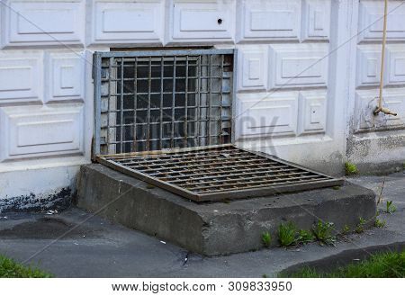The Basement Window With A Metal Barrier
