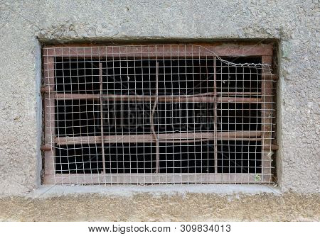 The Basement Window With A Metal Barrier