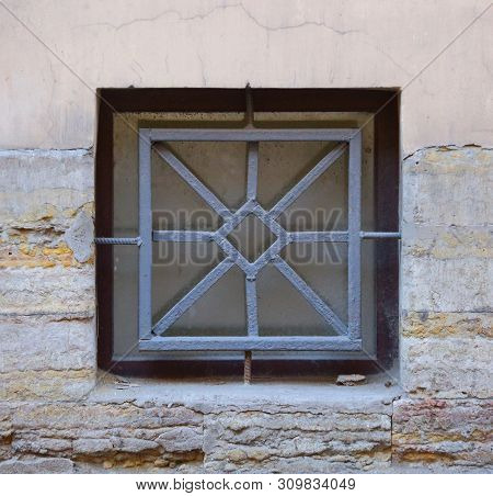The Basement Window With A Metal Barrier