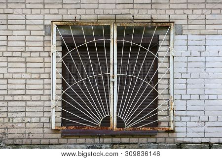 The Basement Window With A Metal Barrier