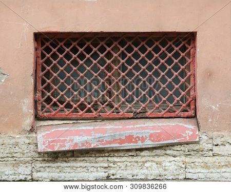 The Basement Window With A Metal Barrier