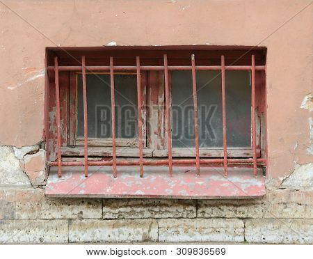 The Basement Window With A Metal Barrier