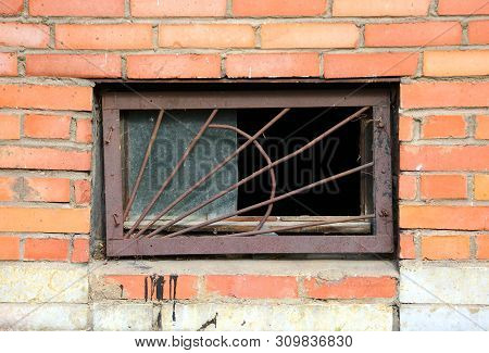 The Basement Window With A Metal Barrier