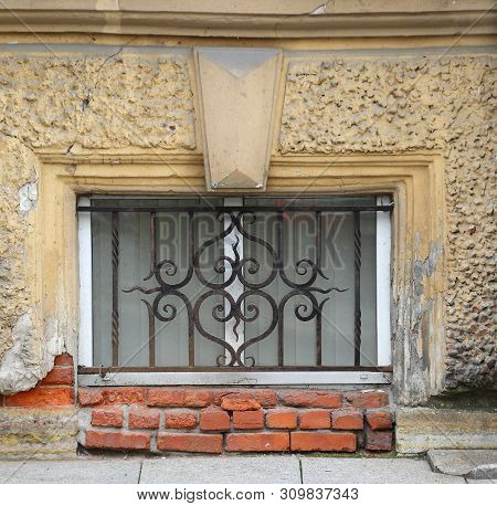 The Basement Window With A Metal Barrier