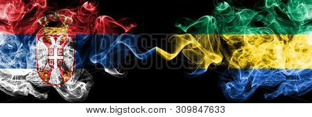 Serbia Vs Gabon, Gabonese Smoky Mystic Flags Placed Side By Side. Thick Colored Silky Smokes Combina