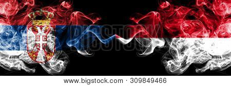 Serbia Vs Monaco, Monacan Smoky Mystic Flags Placed Side By Side. Thick Colored Silky Smokes Combina