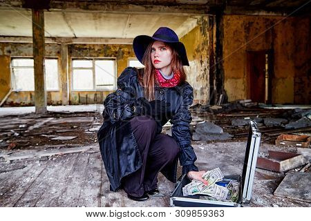 Girl In A Black Cloak With A Diplomat And Money In A Ruined Room. A Spy In A Secret Meeting. Unusual