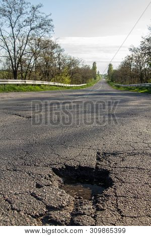 There Are Many Potholes On The Roadway Close Up