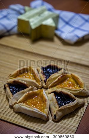 Hamantash Purim Blueberry And Apricot Jam Cookies With Wooden Table Background