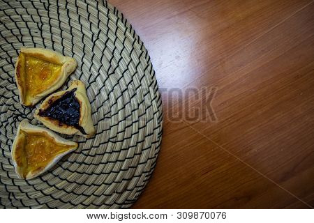 Hamantash Purim Blueberry And Apricot Jam Cookies With Wooden Table Background