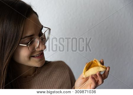 Beautiful And Happy Women Portrait Eating Hamantash Purim Apricot Cookie