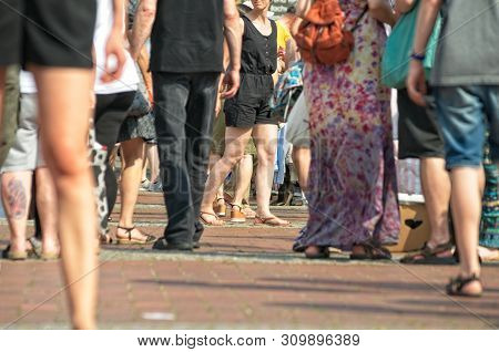 People At A Weekend Flea Market On The Streets With Blurred Background
