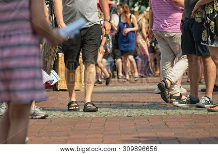 People At A Weekend Flea Market On The Streets With Blurred Background