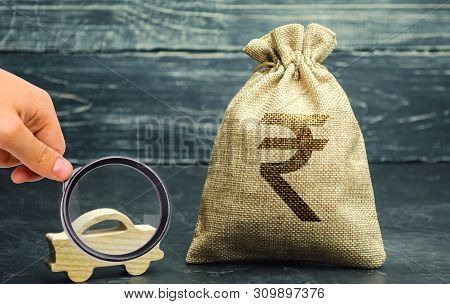 Money Bag With Indian Rupee (rupiah) And Miniature Car. The Concept Of Saving Money To Buy A Car. Au