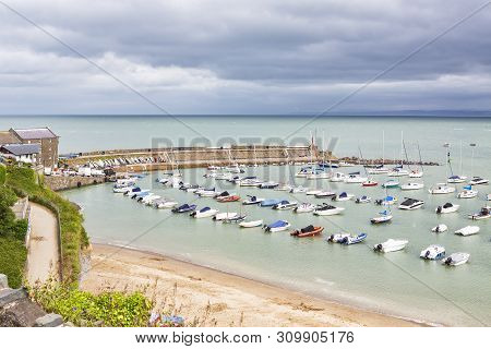 View From Hillside Of New Quay Harbour In West Wales, Uk.
New Quay Is A Picturesque Seaside Town On 
