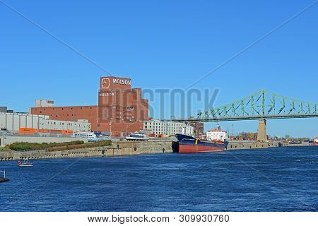Montreal, Canada - Nov 2, 2012: Molson`s First Brewery And Jacques Cartier Bridge At St. Lawrence Ri