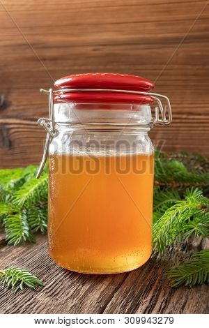 A Jar Of Homemade Herbal Syrup Against Cough Made From Young Spruce Tips