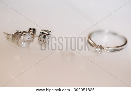 Precious Silver Ring And Earrings With Diamond On White Background. Bridas Wedding Accessories Conce