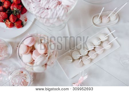Close-up Photo Of Elegant Sweet Table Of Pink Macaroons, Zefir And Tasty Strawberry. Wedding Delicio