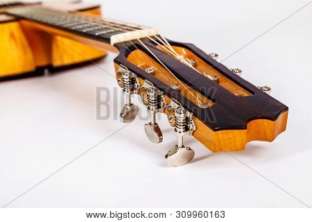 Tuning Pegs On Wooden Machine Head Of Six Strings Guitar On White Background