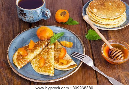 Wheat Pancakes With Honey And Apricots. Photo