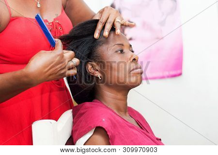 The Hairdresser Creates A Model Of Hair On The Head Of Her Clent.