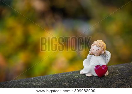 Angel Holds A Heart In His Hand.