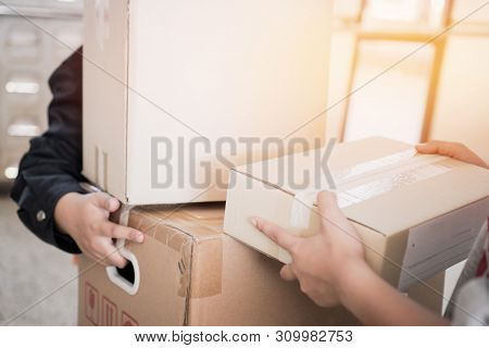 Deliveryman Get Parcel Box Package To Asian Customer Accepting Delivery Of Boxes Packages From Deliv