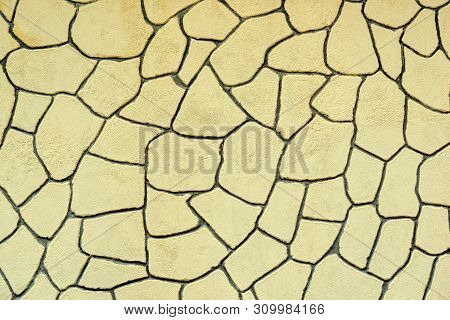 The Plastered Wall With An Abstract Mesh Mosaic Pattern Of Monotonous Yellow Color For The Textured 