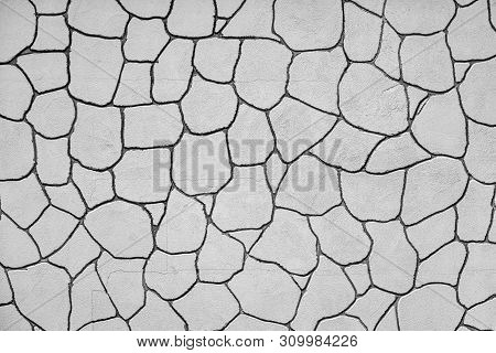 The Plastered Wall With An Abstract Mesh Mosaic Pattern Of Monotonous Gray Color For The Textured Ba