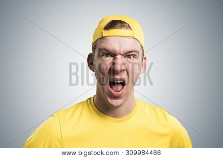 Frenzied Teenager Screaming With Anger. Emotional Redhead Boy Has Furious Facial Expression. Portrai